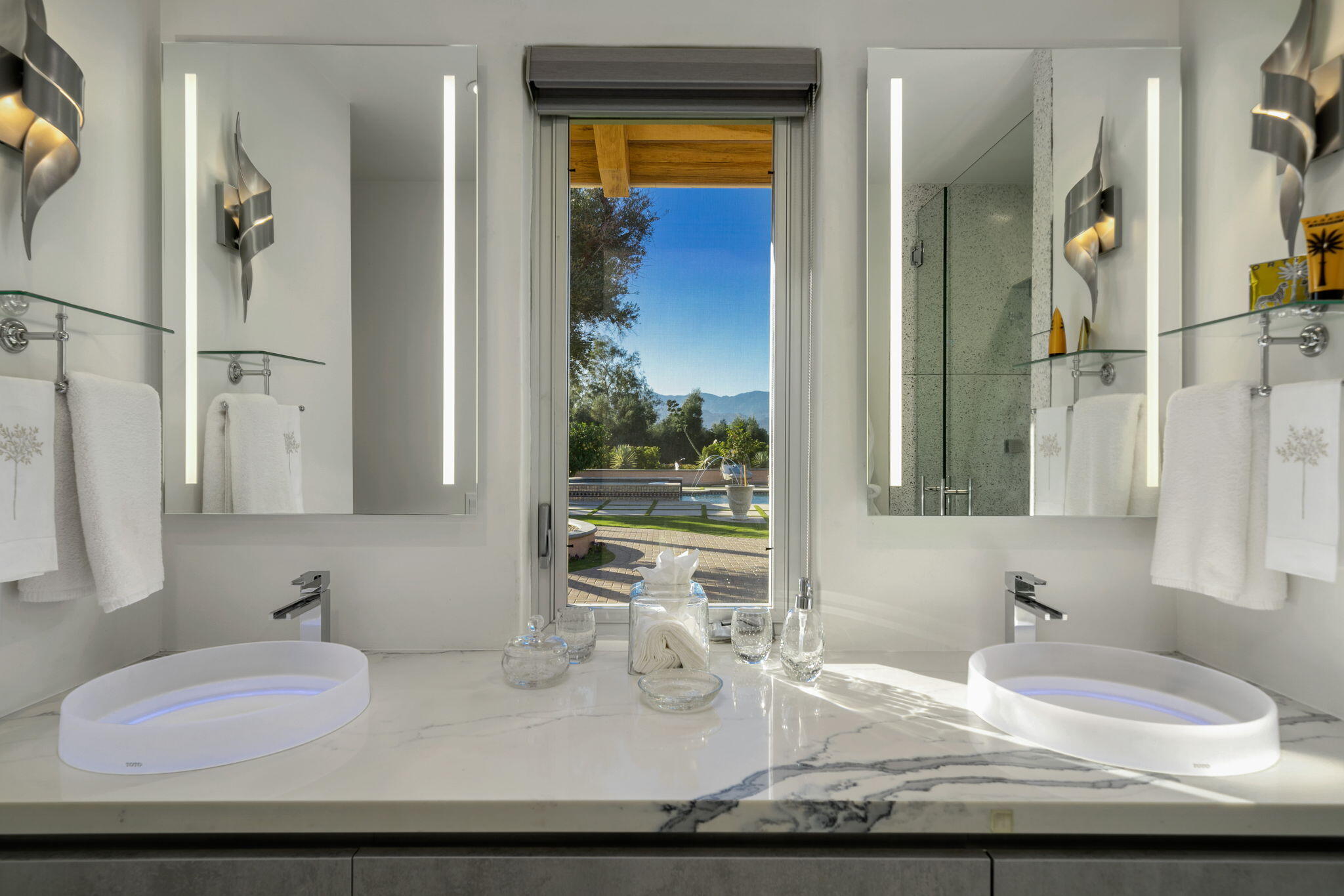 51555 Madison Street La Quinta, CA 92253 - Photo 17 of 25 a bathroom with a granite countertop sink and a mirror