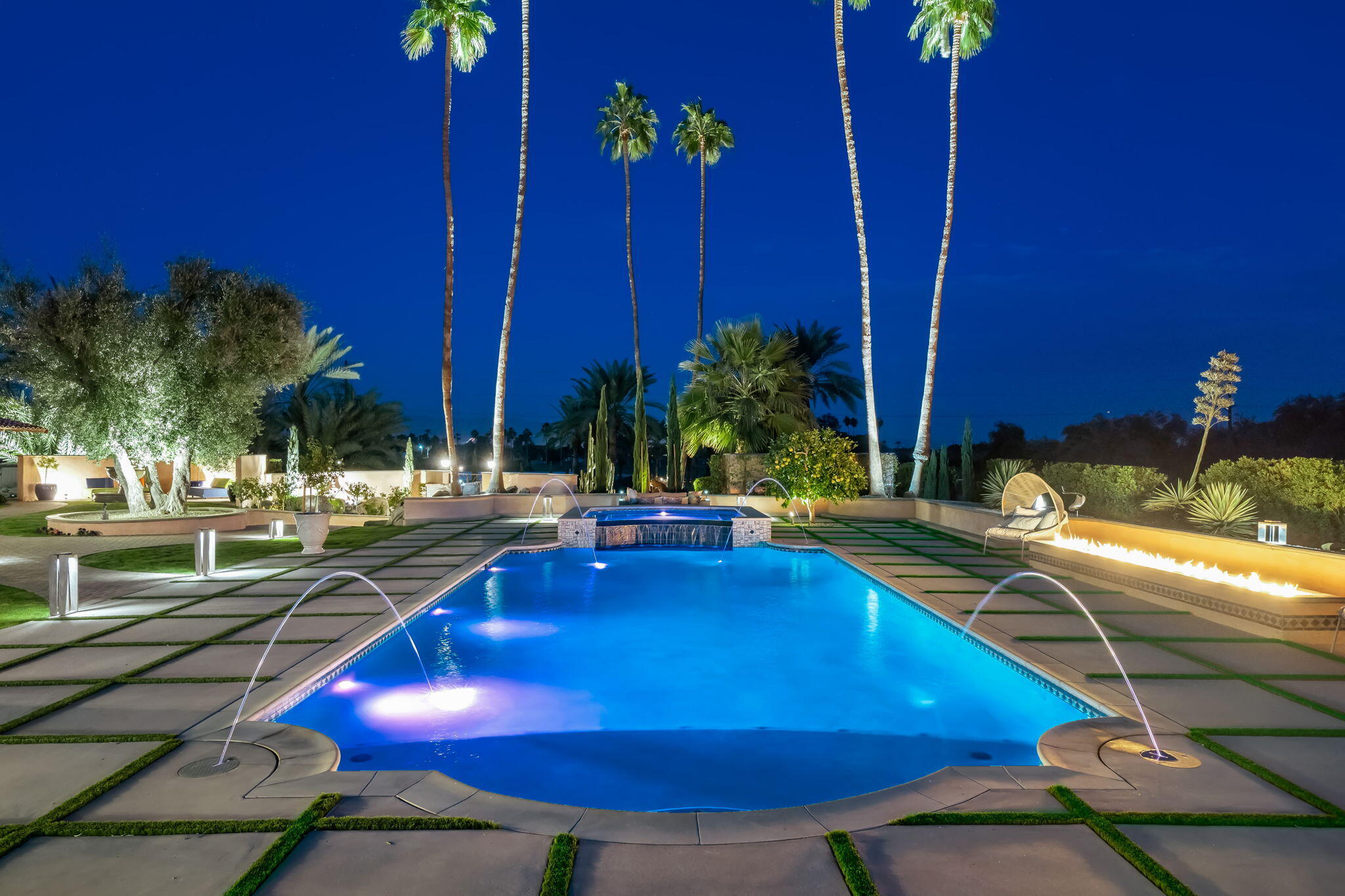 51555 Madison Street La Quinta, CA 92253 - Photo 21 of 25 a view of a swimming pool with lawn chairs under an umbrella