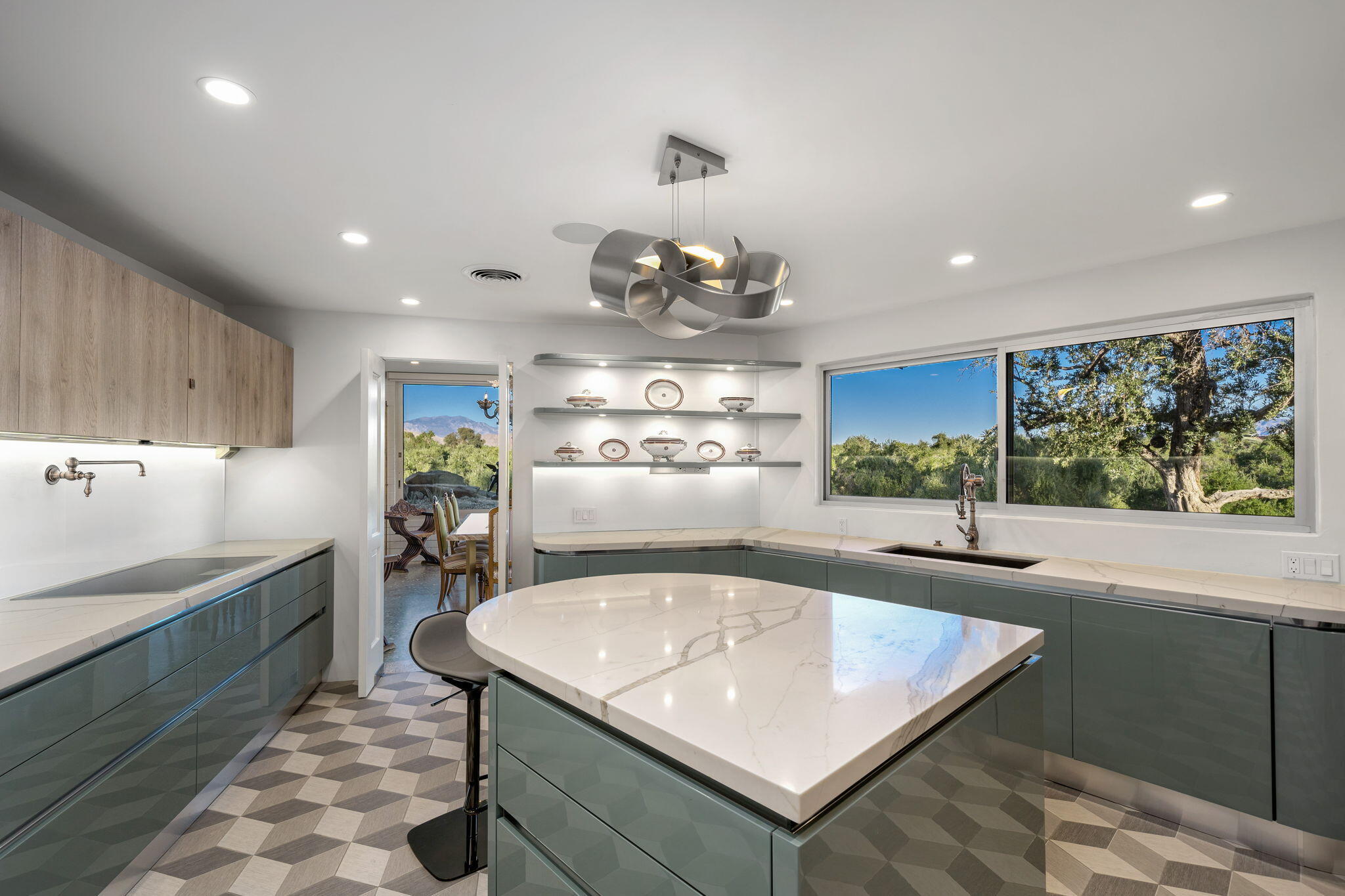 51555 Madison Street La Quinta, CA 92253 - Photo 3 of 25 a kitchen with stainless steel appliances granite countertop a sink a stove and a wooden cabinets