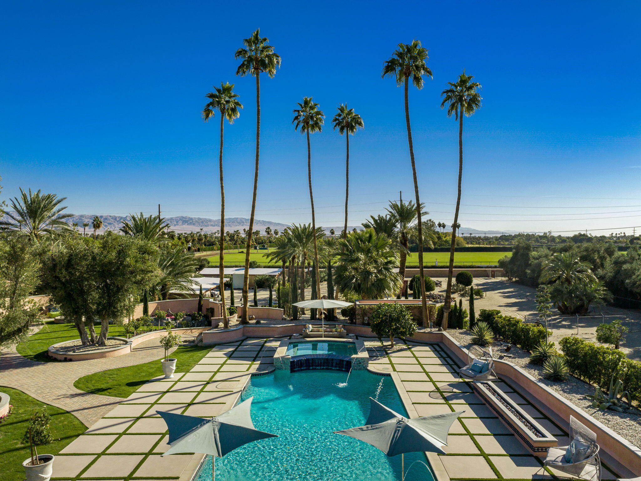 51555 Madison Street La Quinta, CA 92253 - Photo 6 of 25 a view of a swimming pool with chairs