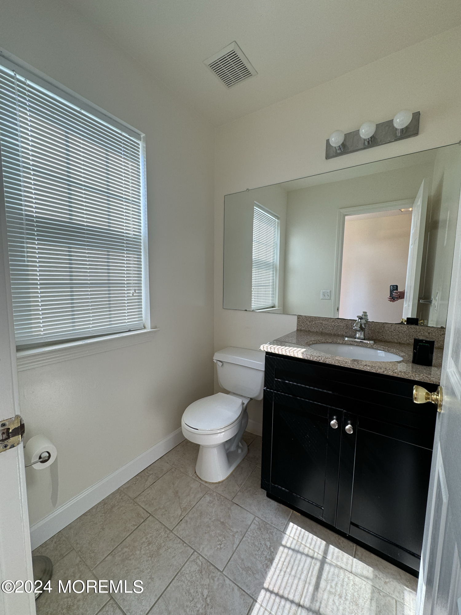 28 Alpine Road, Unit 177 Holmdel, NJ 07733 - Photo 9 of 17 a bathroom with a sink vanity and a toilet