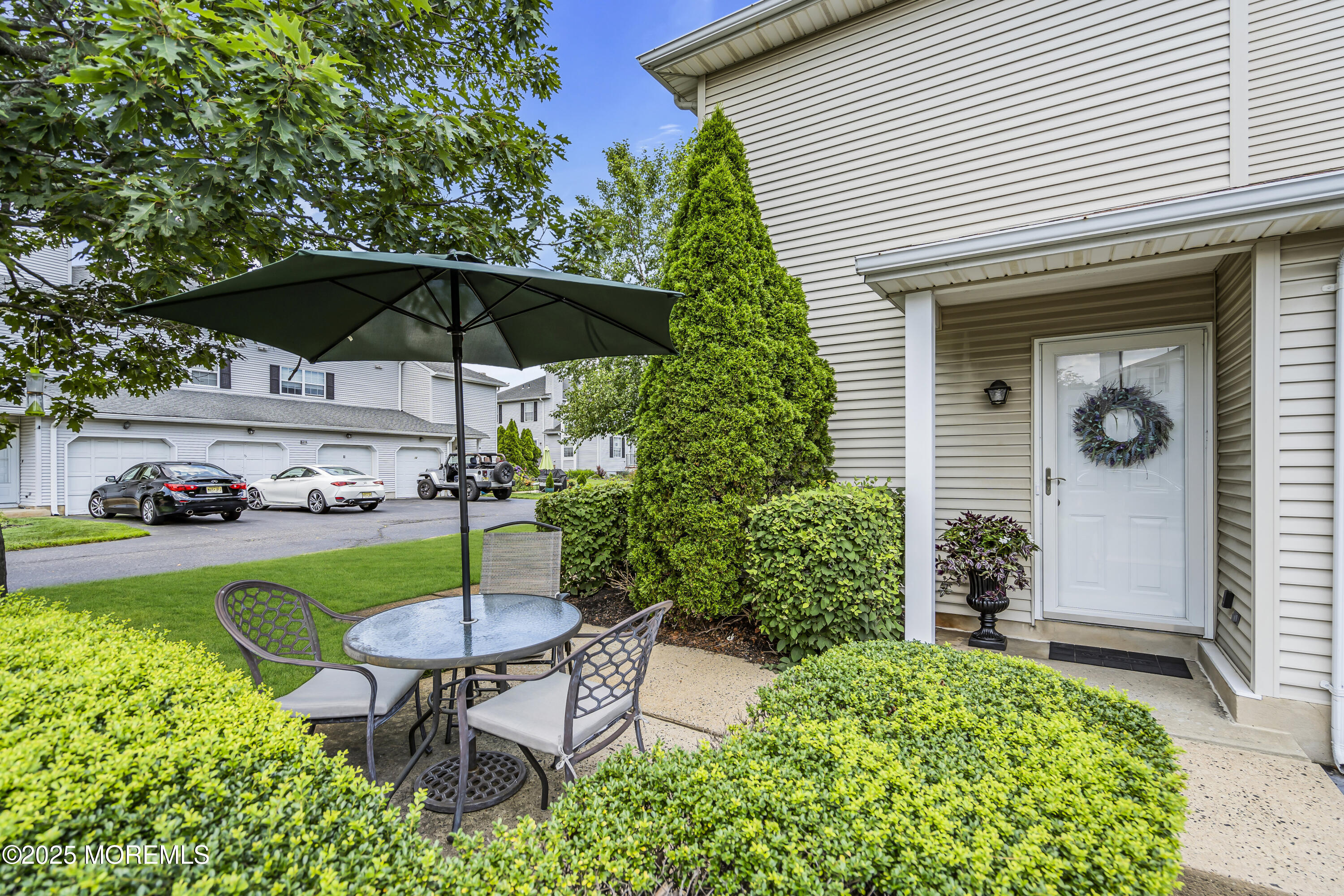 32 Racquet Road Wall, NJ 07719 - Photo 1 of 23 a view of a chair and table under an umbrella