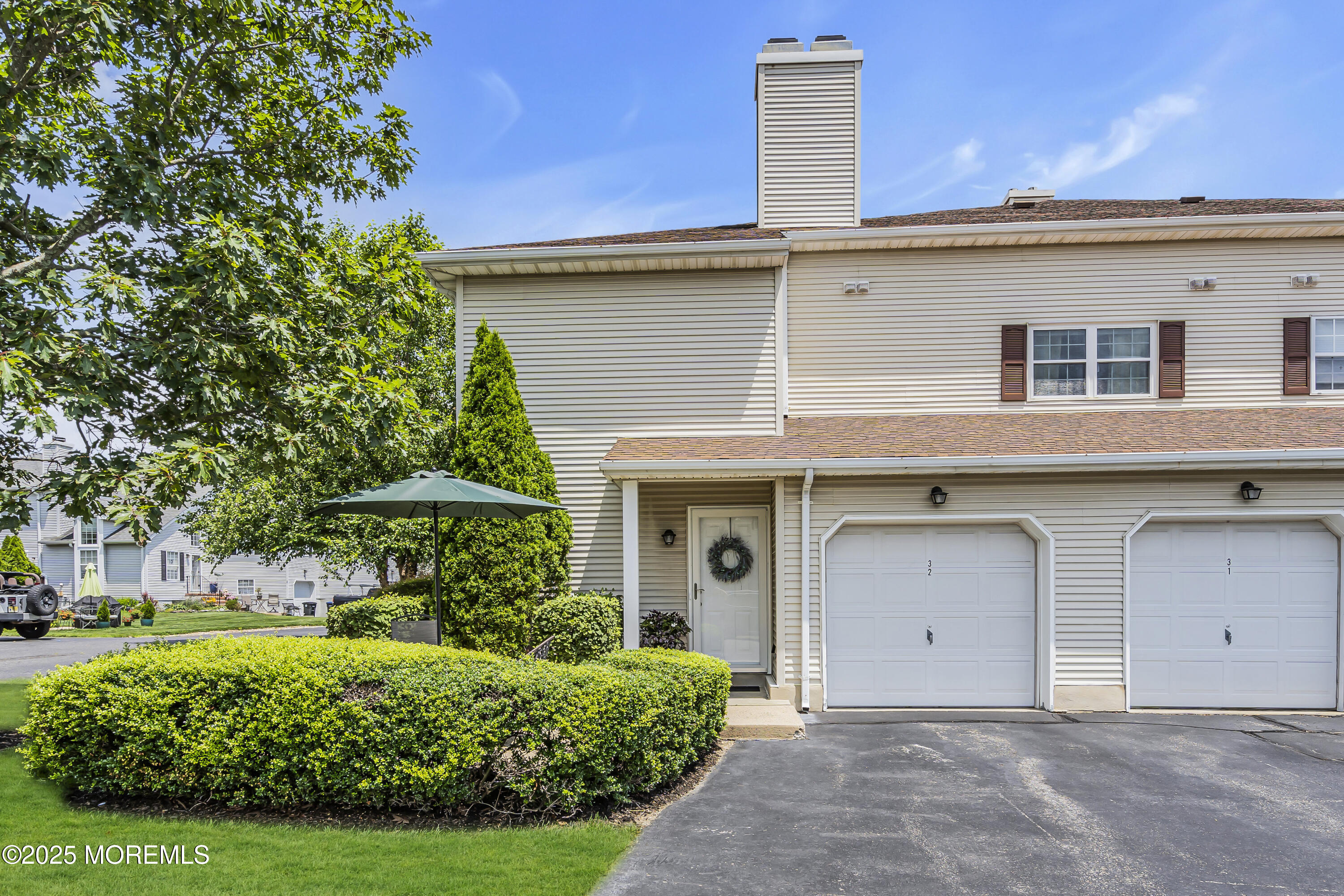 32 Racquet Road Wall, NJ 07719 - Photo 2 of 23 a view of a white house with a yard and plants