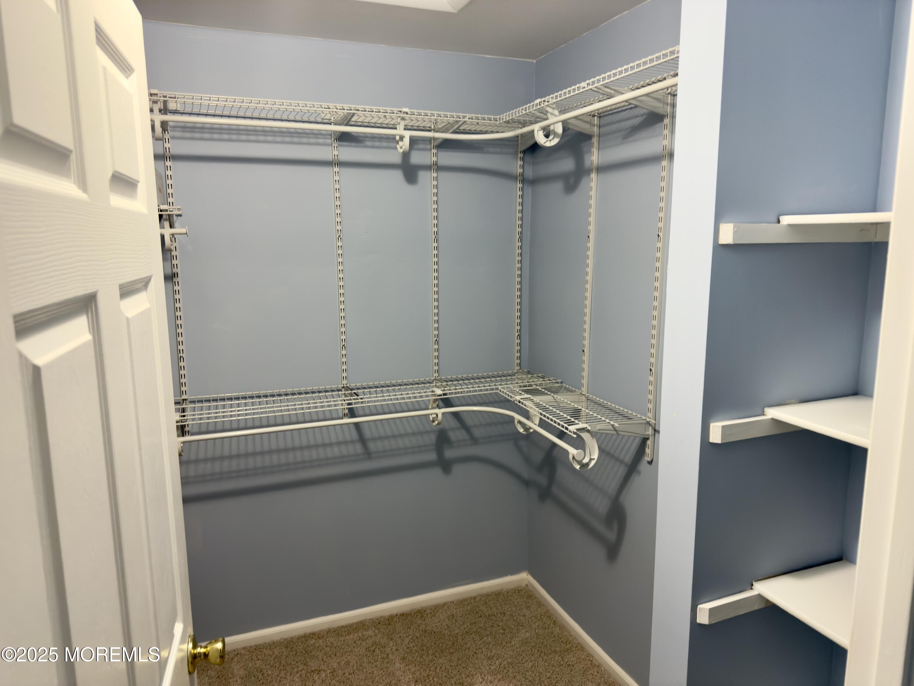 32 Racquet Road Wall, NJ 07719 - Photo 22 of 23 a view of walk in closet with empty racks