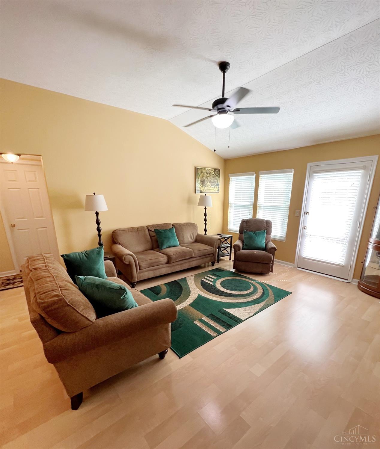 8408 Ridge Pointe Court, Unit 13 Reading, OH 45237 - Photo 3 of 39 Here's the living room: laminate flooring, cathedral ceiling, lighted ceiling fan and access to the deck