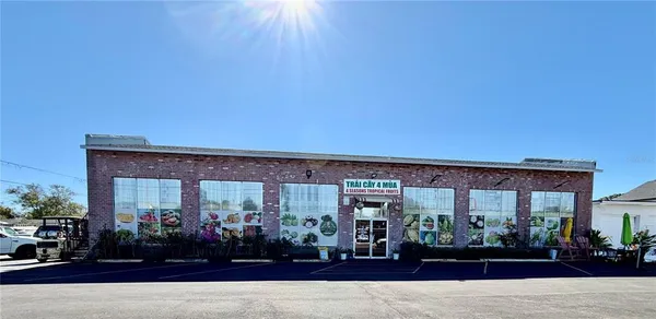 a front view of a building with lots of potted plants