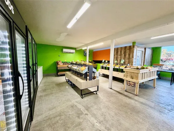 a living room filled with furniture and a floor to ceiling window