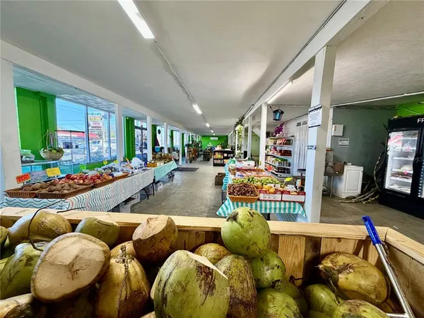 a living room with furniture a floor to ceiling window and a flat screen tv