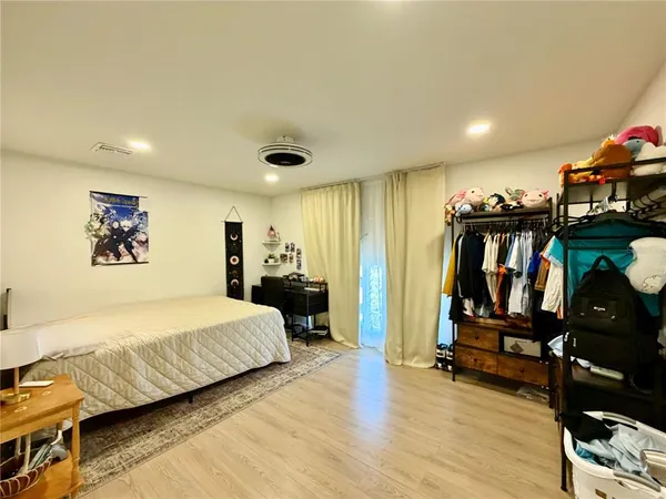 a kitchen with stainless steel appliances granite countertop a refrigerator a stove and a dining table with wooden floor