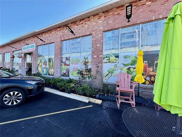 a view of a patio with table and chairs potted plants and wooden fence