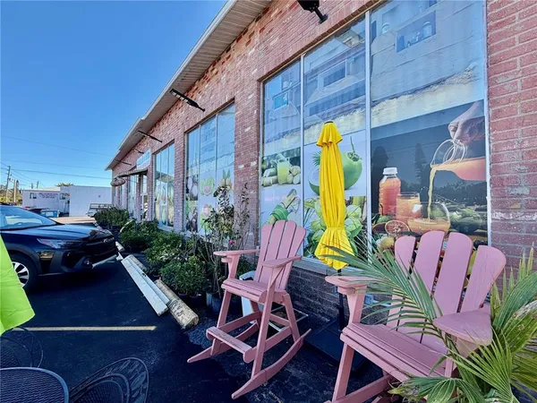 a view of a chairs and table in patio
