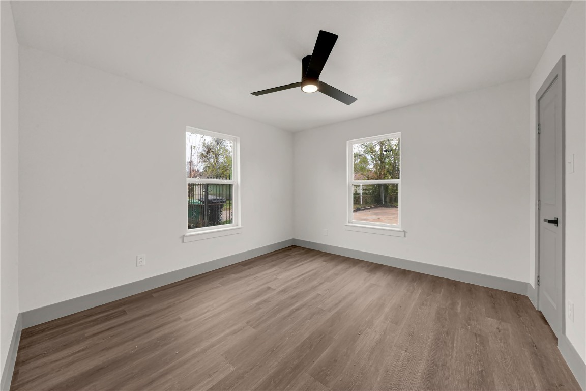 4331 Herridge Street Houston, TX 77022 - Photo 15 of 32 a view of an empty room with wooden floor and a window