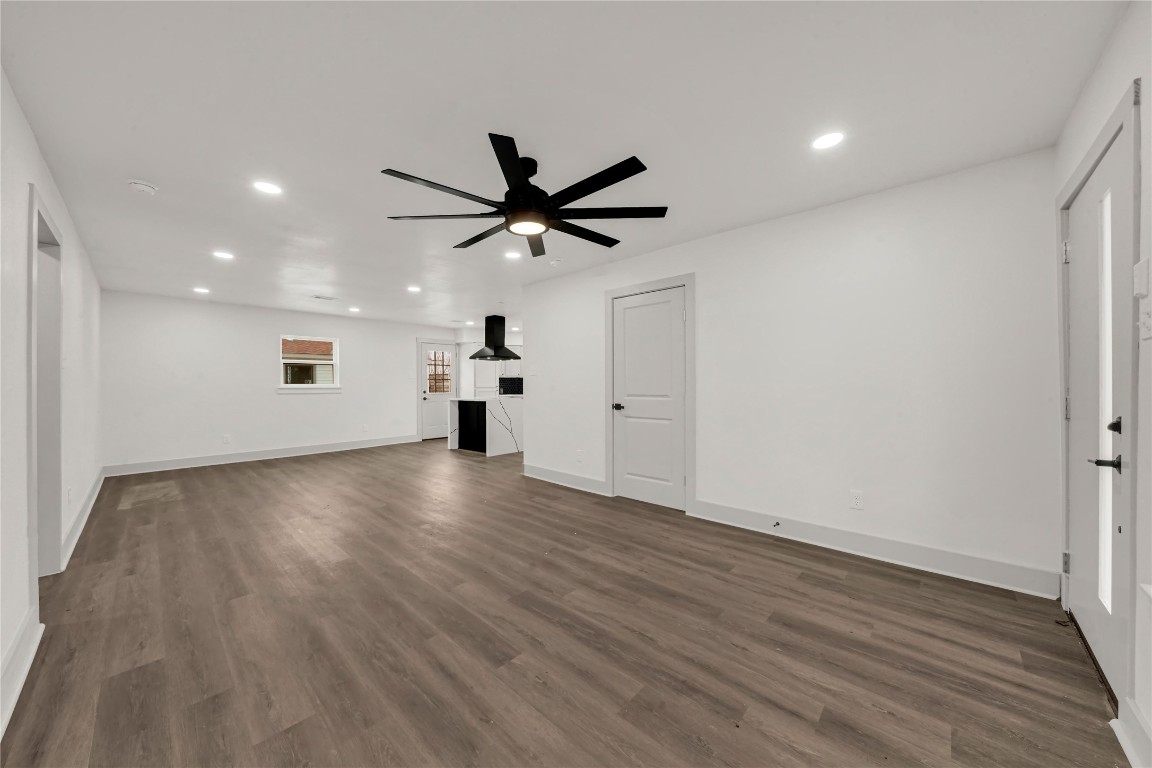 4331 Herridge Street Houston, TX 77022 - Photo 3 of 32 a view of an empty room with wooden floor and a ceiling fan