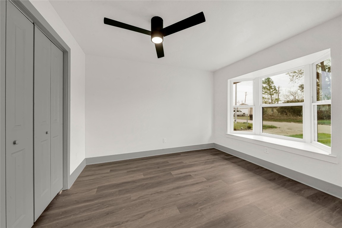 4331 Herridge Street Houston, TX 77022 - Photo 9 of 32 a view of an empty room with wooden floor and a window