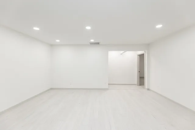 an empty room with a empty space and windows