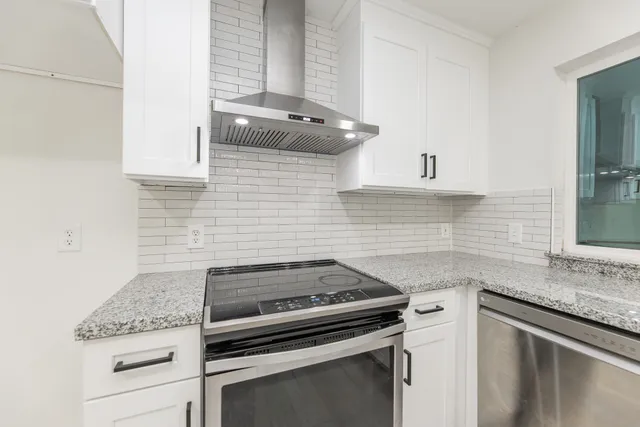 a kitchen with granite countertop cabinets stainless steel appliances and a sink