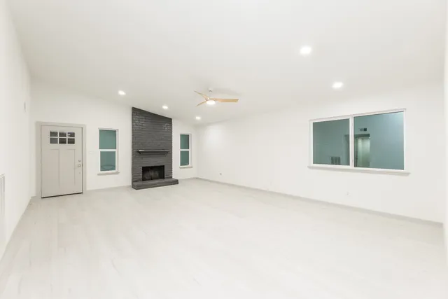 a view of an empty room with kitchen