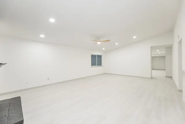 an empty room with a projector and white walls