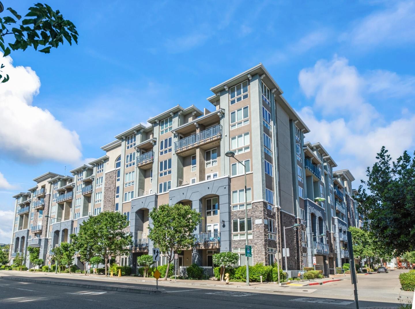 a view of a tall building next to a road