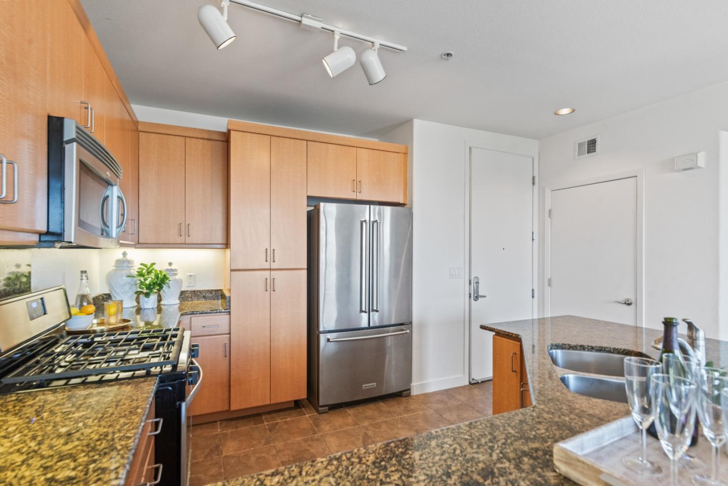5501 De Marcus Boulevard, Unit 519 Dublin, CA 94568 - Photo 13 of 31 a kitchen with stainless steel appliances granite countertop a refrigerator sink and stove