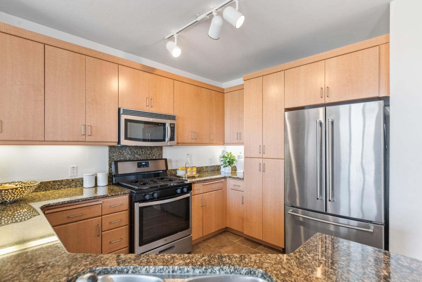 5501 De Marcus Boulevard, Unit 519 Dublin, CA 94568 - Photo 14 of 31 a kitchen with stainless steel appliances granite countertop a refrigerator stove and sink