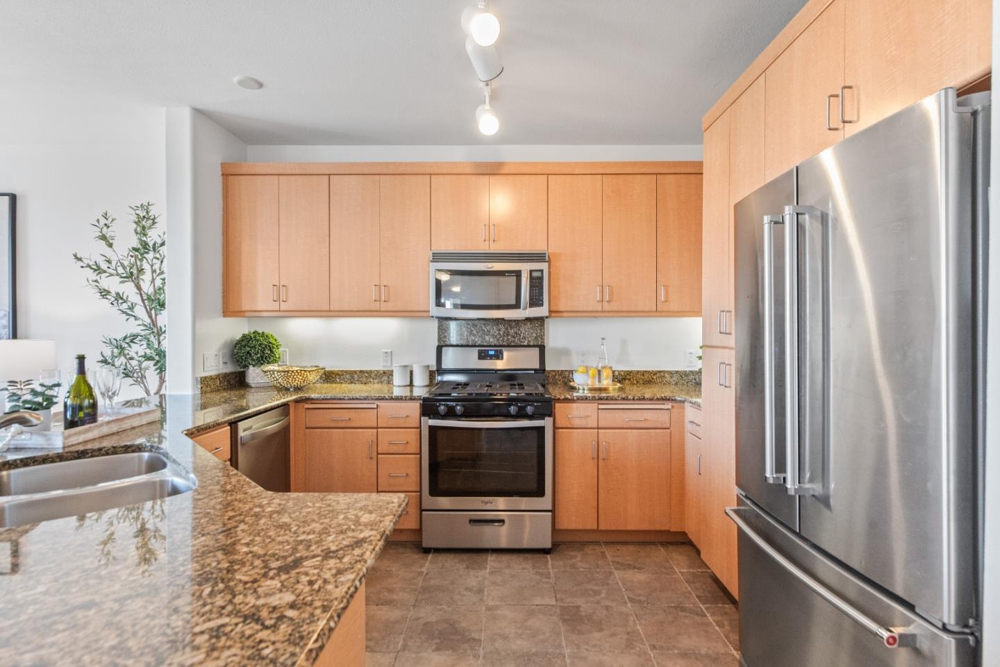 5501 De Marcus Boulevard, Unit 519 Dublin, CA 94568 - Photo 15 of 31 a kitchen with stainless steel appliances granite countertop a refrigerator a stove and a sink