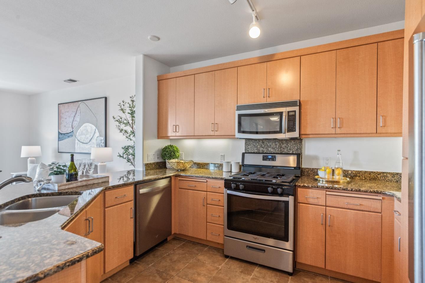 5501 De Marcus Boulevard, Unit 519 Dublin, CA 94568 - Photo 16 of 31 a kitchen with stainless steel appliances granite countertop a stove a sink and a microwave