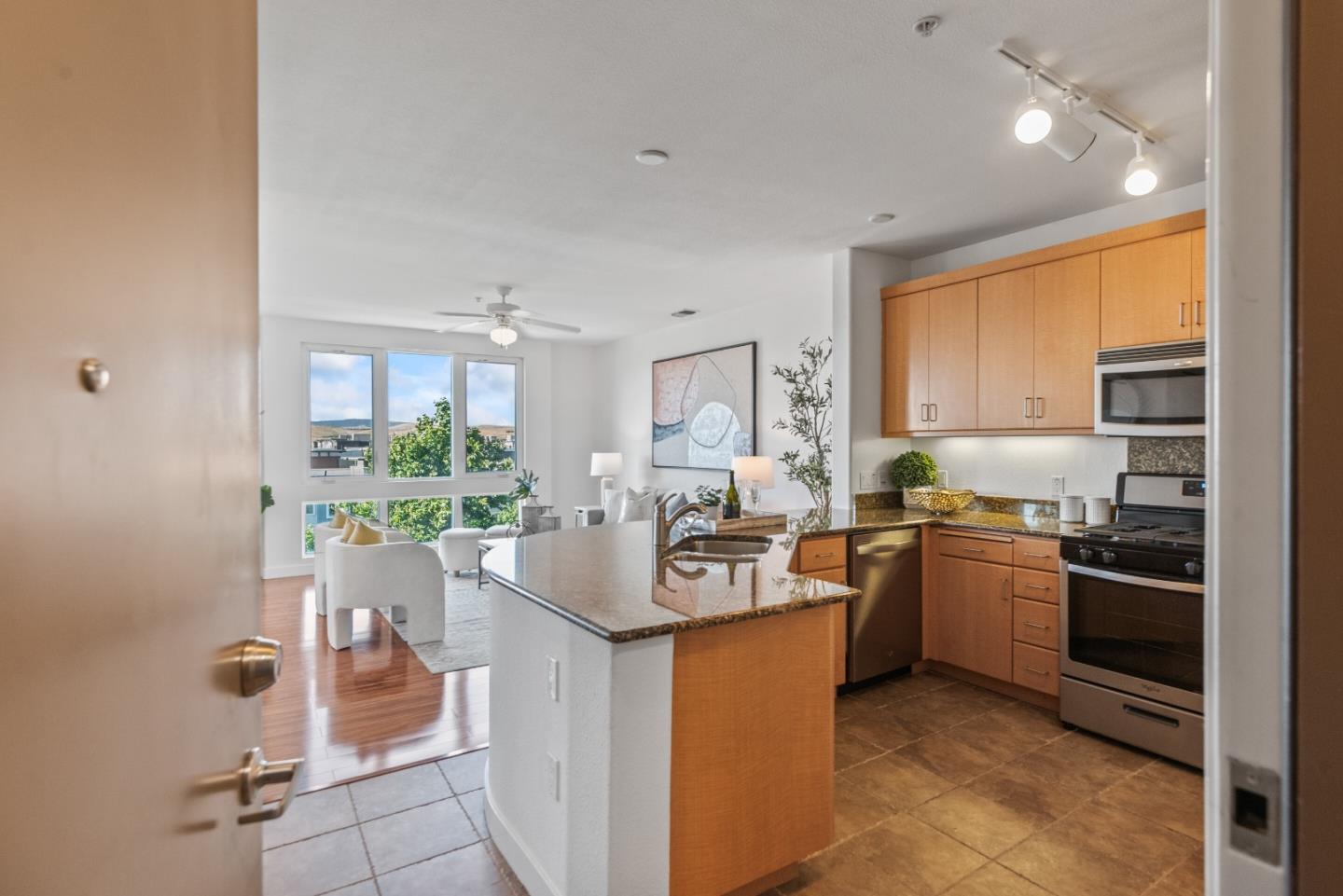 5501 De Marcus Boulevard, Unit 519 Dublin, CA 94568 - Photo 3 of 31 a kitchen with stainless steel appliances kitchen island granite countertop a sink and cabinets