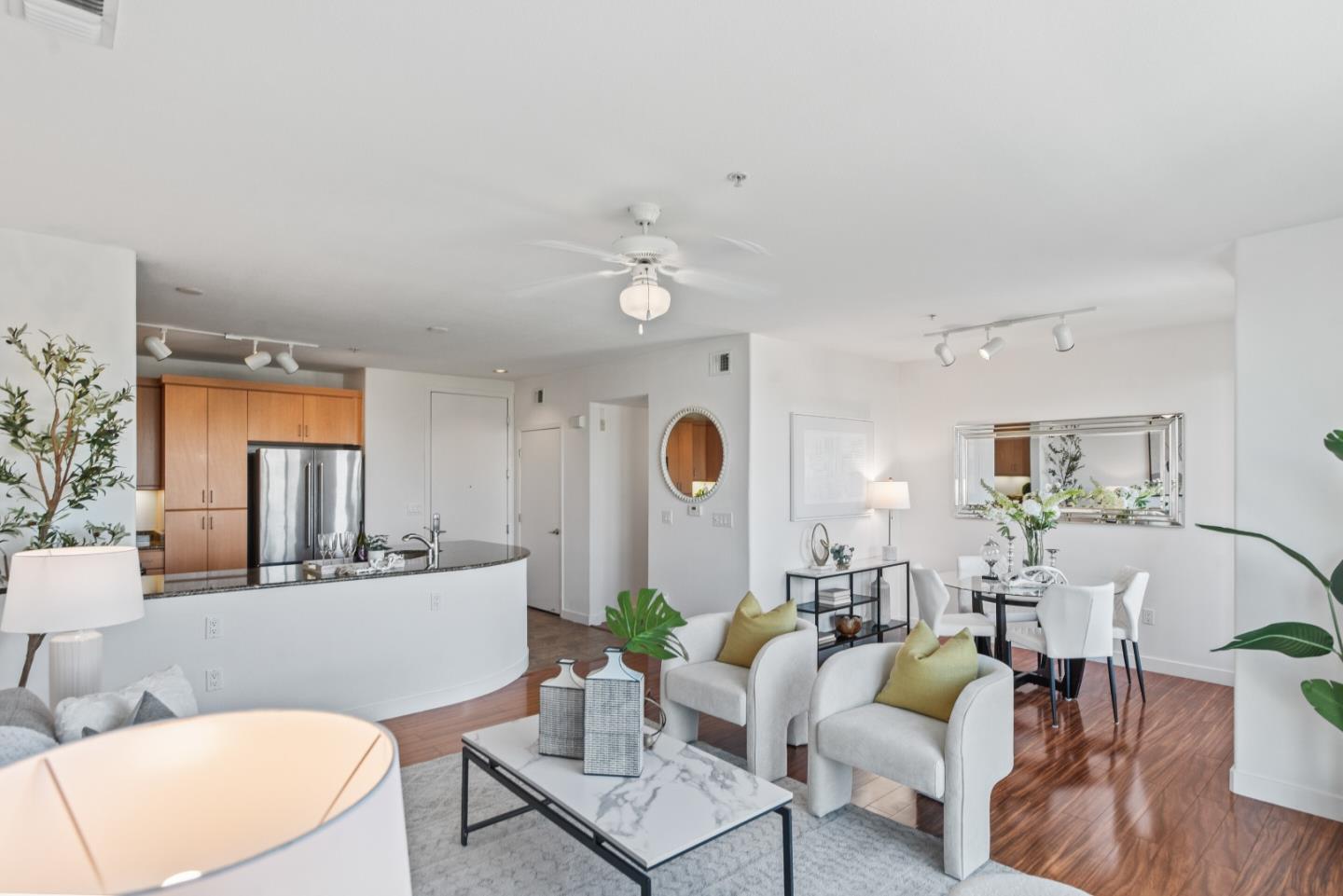 5501 De Marcus Boulevard, Unit 519 Dublin, CA 94568 - Photo 8 of 31 a living room with furniture a fireplace and a table