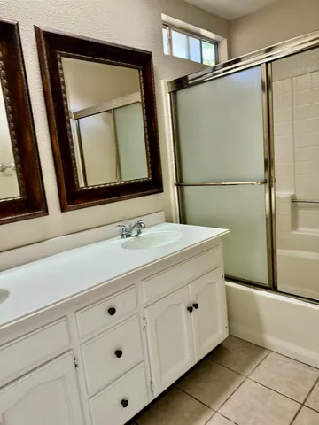 a bathroom with a double vanity sink mirror and