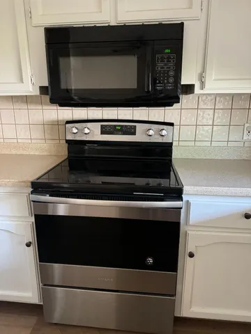 a stove top oven sitting inside of a kitchen