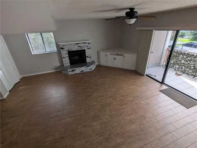 an empty room with windows dryer and fireplace
