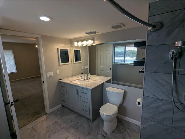 a bathroom with a sink toilet and shower