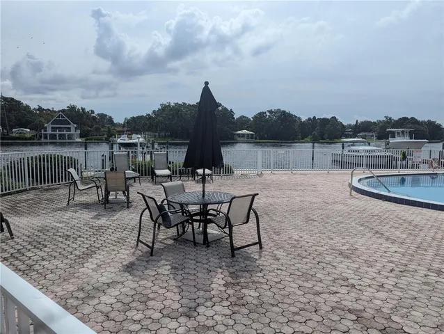 a view of a lake with table and chairs