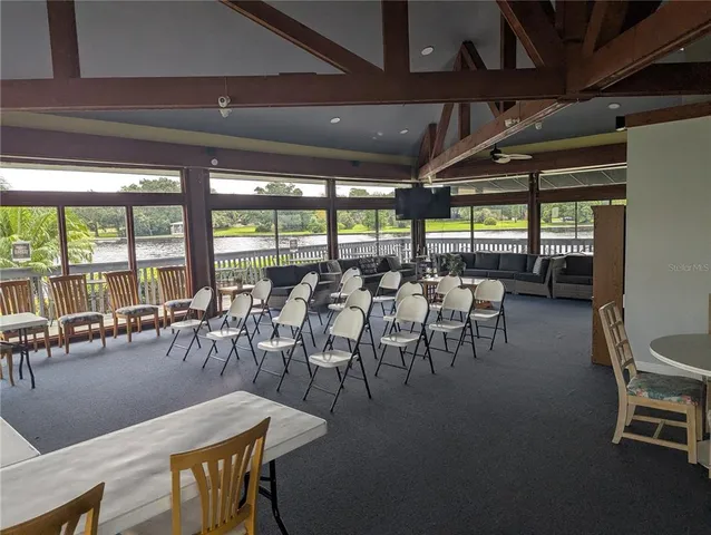 a outdoor space with lots of chairs and view of dining room