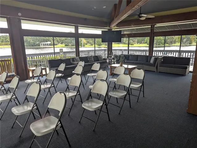 a dining room with furniture and a floor to ceiling window