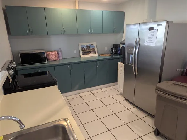 a kitchen with stainless steel appliances a refrigerator and a sink