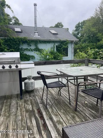 a view of a patio with table and chairs and potted plants