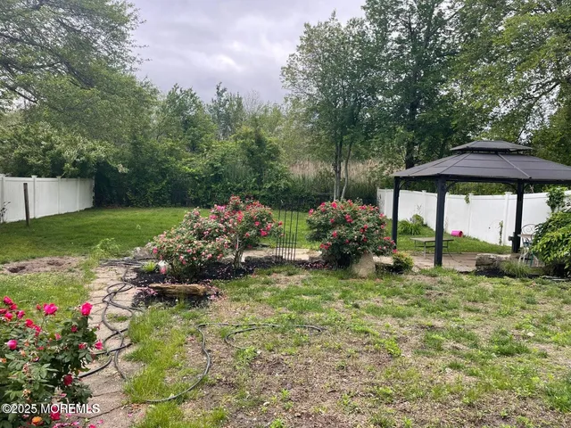 a view of a chair and table in the garden