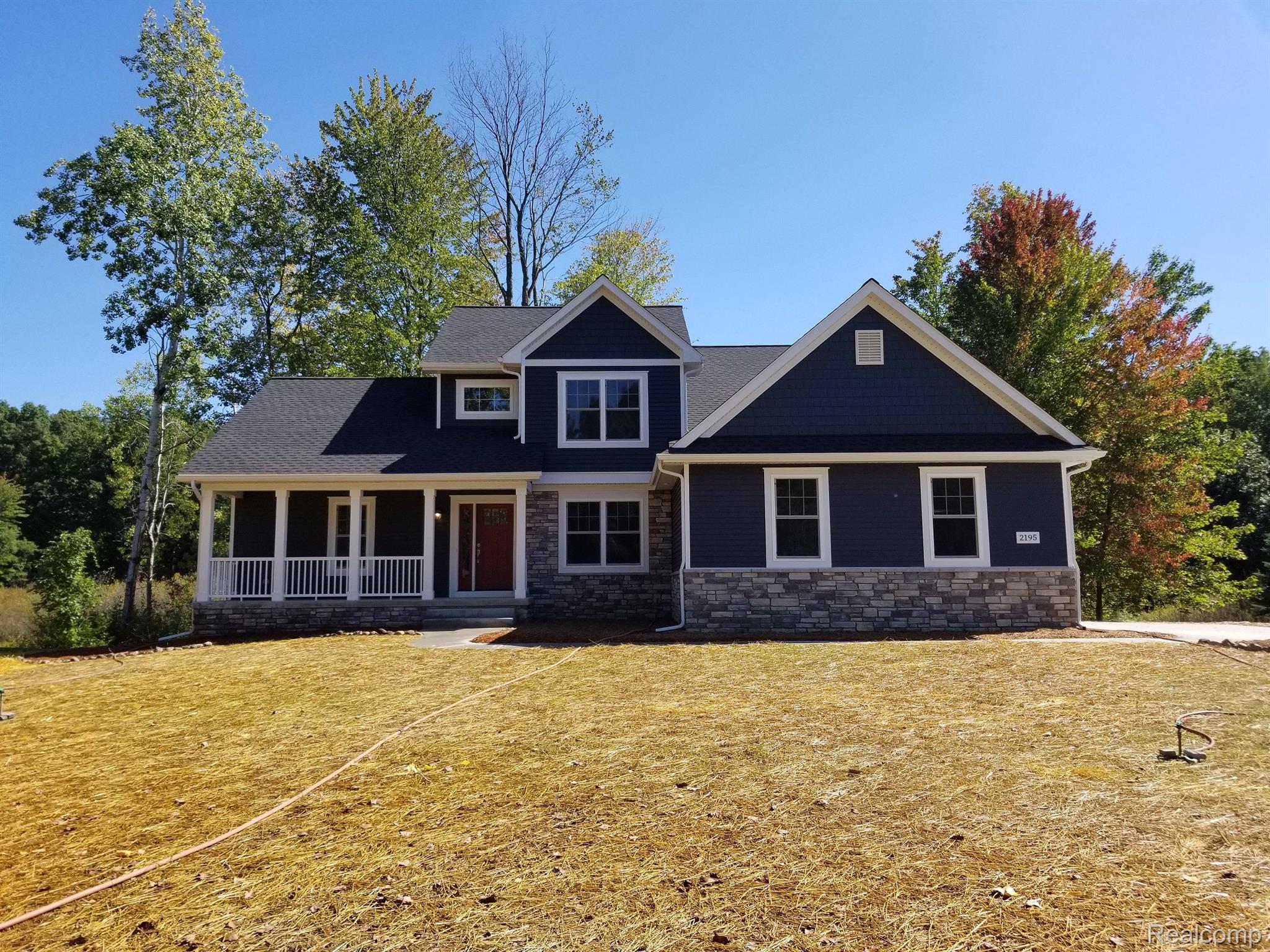 2195 Sundance Ridge Howell, MI 48843 - Photo 1 of 24 FRONT ELEVATION AND YARD