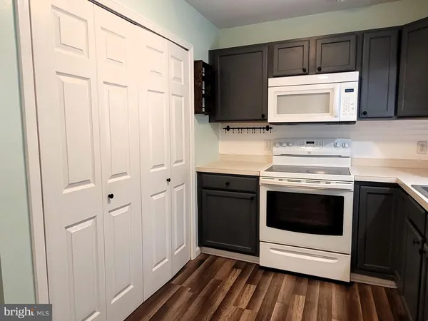 a kitchen with stainless steel appliances a stove microwave and sink