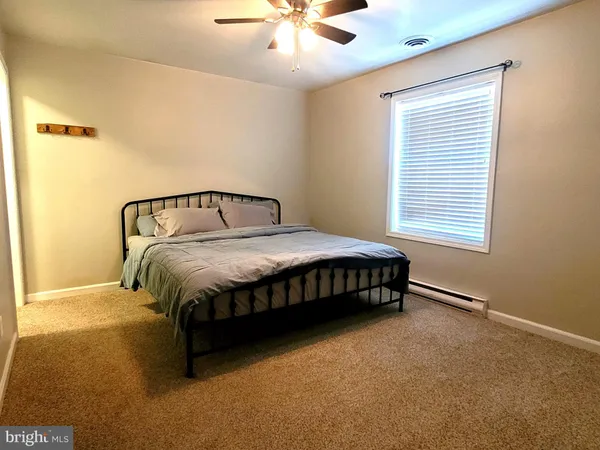 a bedroom with a bed and window