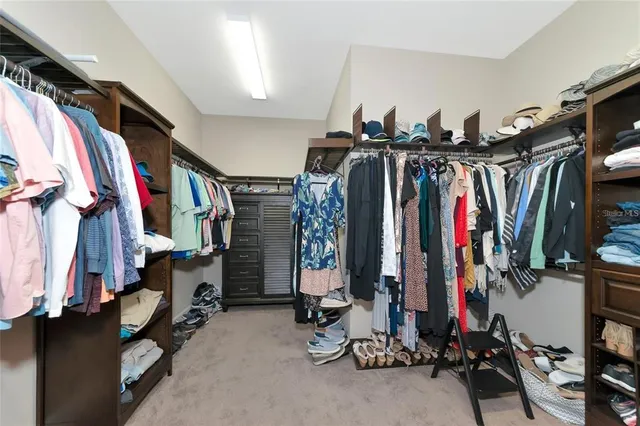 a view of walk in closet with clothes
