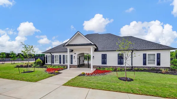 a swimming pool with outdoor seating and barbeque oven