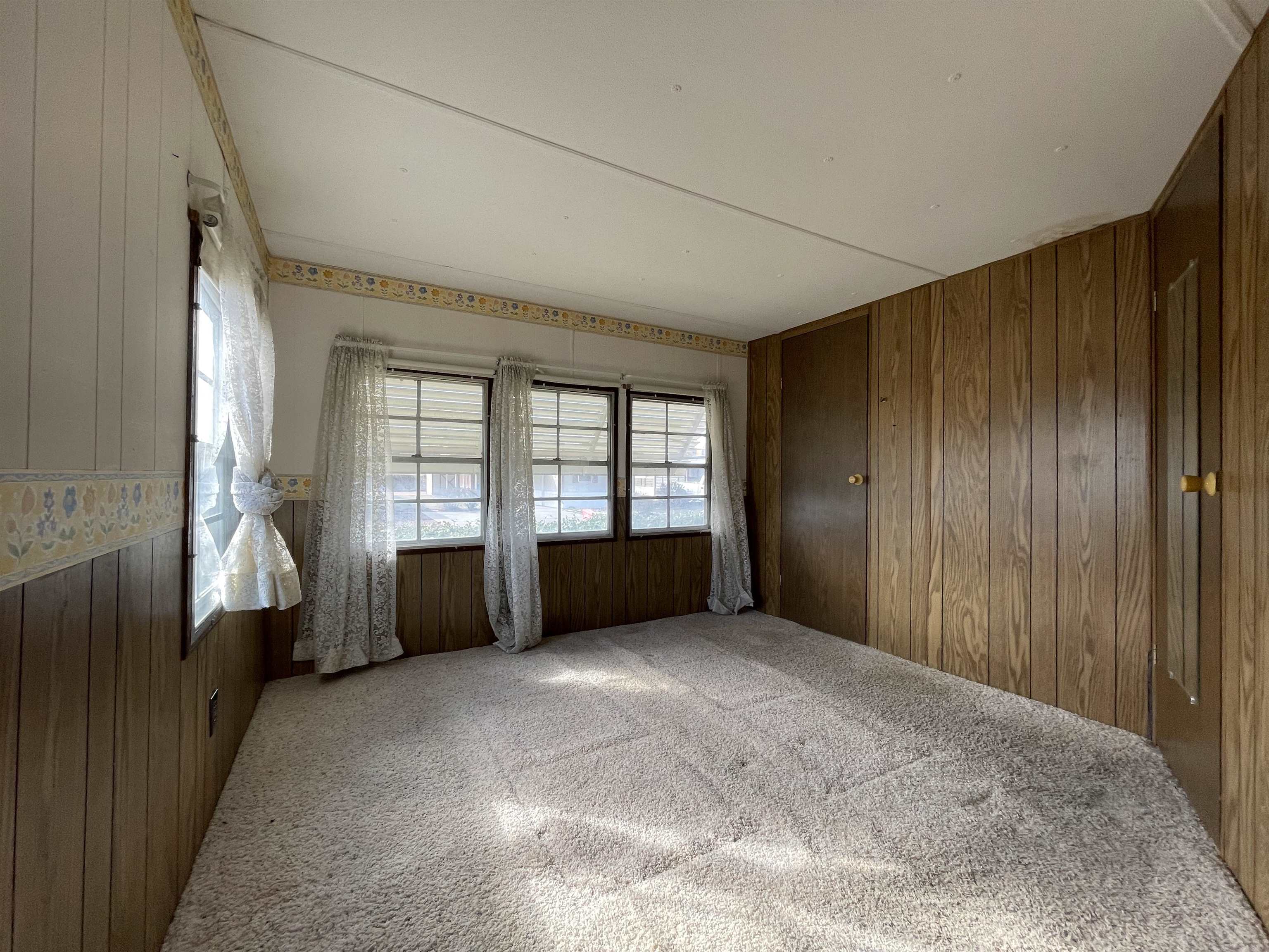 3251 E Road, Unit 102 Clifton, CO 81520 - Photo 11 of 14 an empty room with windows