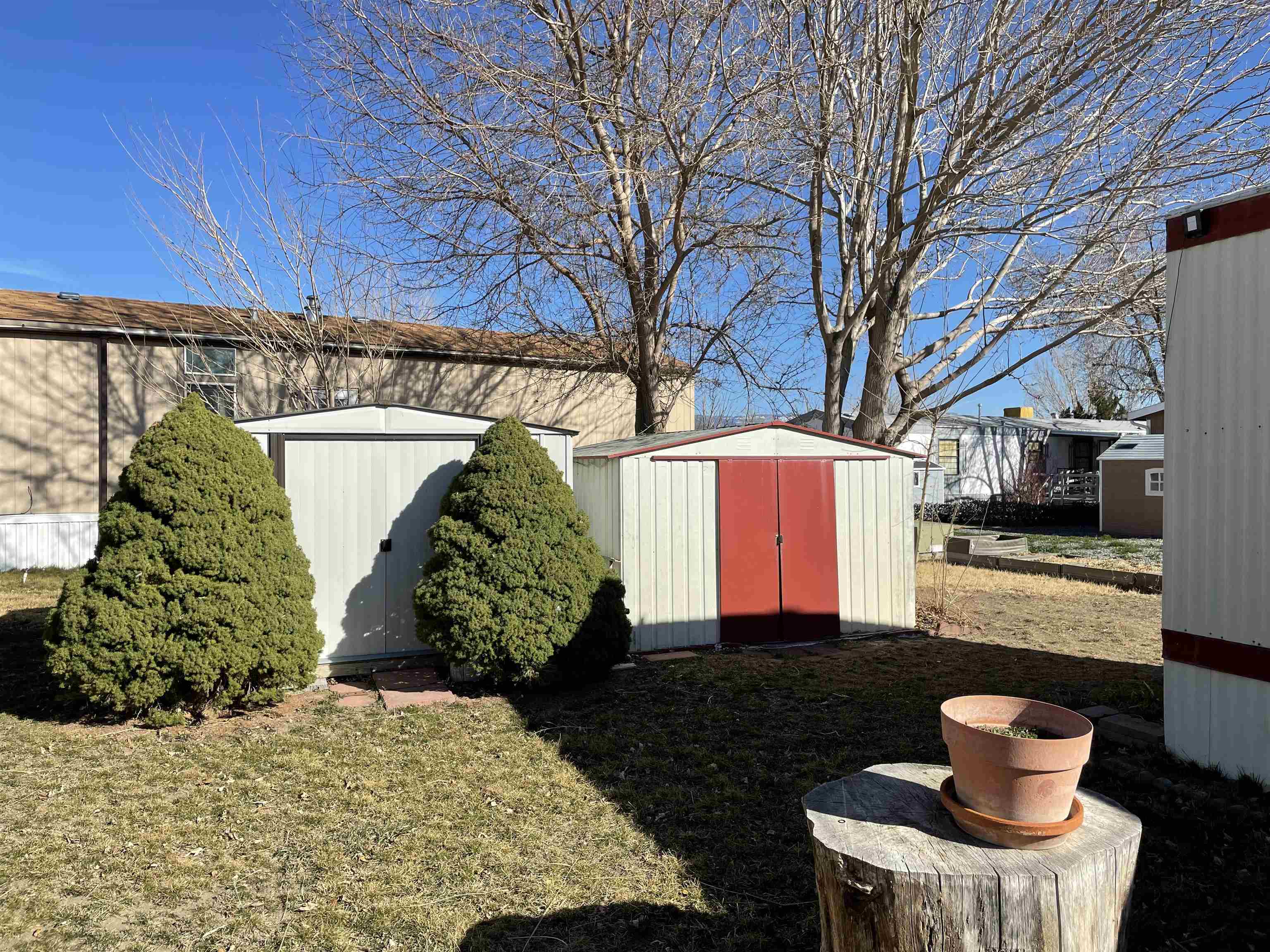 3251 E Road, Unit 102 Clifton, CO 81520 - Photo 14 of 14 a front view of a house with a yard and potted plants