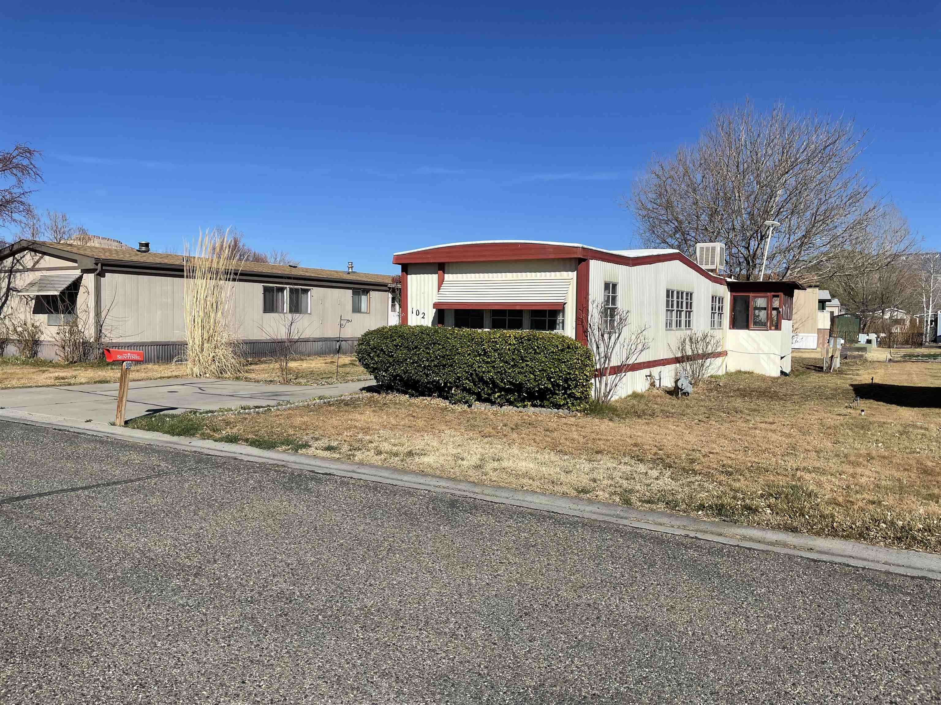 3251 E Road, Unit 102 Clifton, CO 81520 - Photo 2 of 14 a front view of a house with a yard