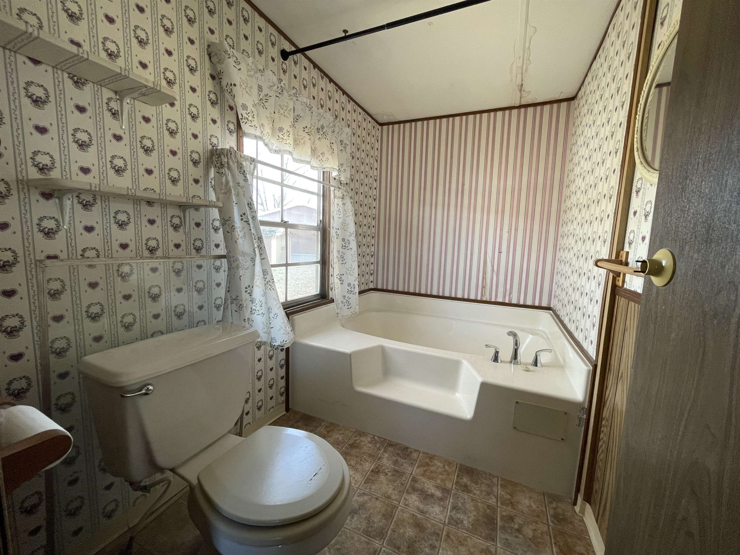 3251 E Road, Unit 102 Clifton, CO 81520 - Photo 9 of 14 a bath room with a toilet a bath tub and a shower