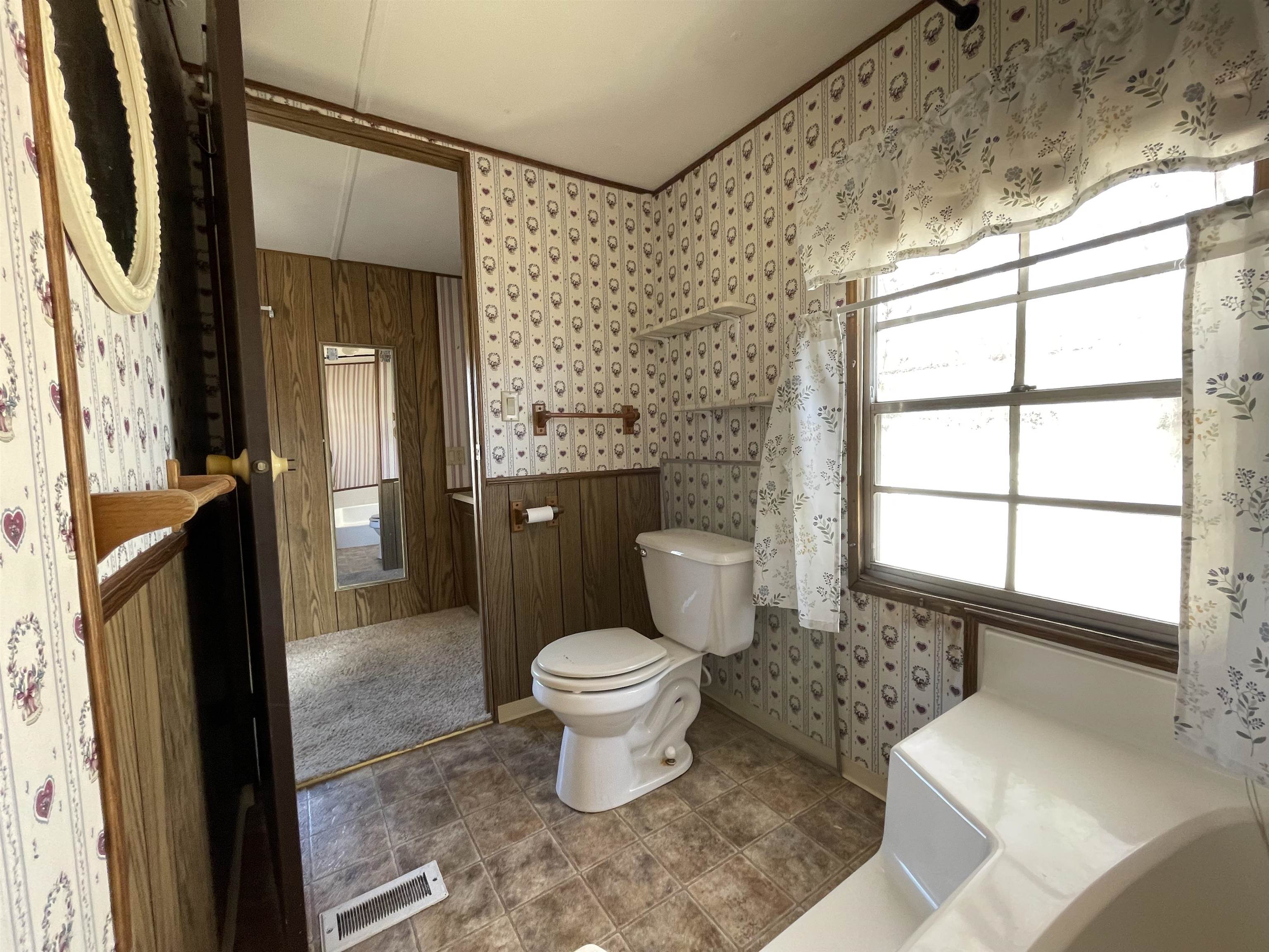 3251 E Road, Unit 102 Clifton, CO 81520 - Photo 10 of 14 a bathroom with a toilet sink and a mirror