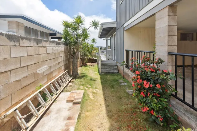 a view of balcony with wooden floor and fence and a potted plant